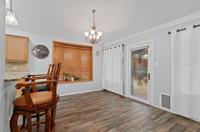 Dining room featuring dark wood-style floors, orna