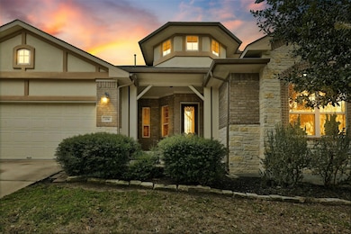 View of front of home with a garage, stone siding