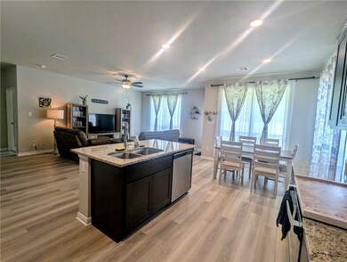 Kitchen with a sink, dishwasher, open floor plan,