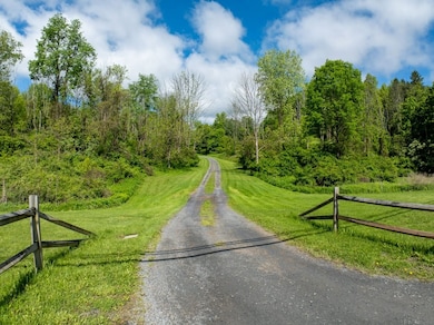 Privately set off the road, this home offers 10 ac