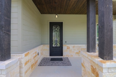 Covered front porch with iron door.
