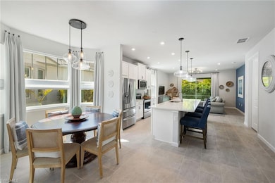 Dining area with recessed lighting and baseboards