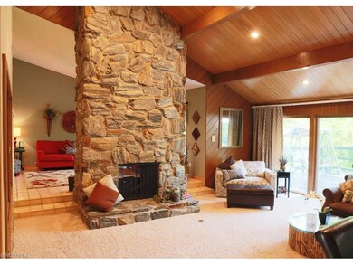 Family room features stone to ceiling gas fireplac