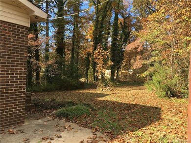 Secluded backyard is partially fenced.