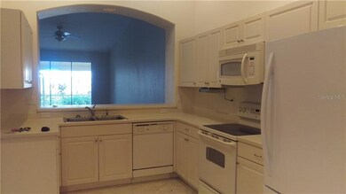 Neutral kitchen w/corian counters and lots of cabi