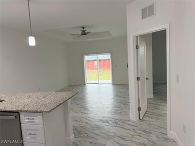 Kitchen with light marble finish flooring, a tray