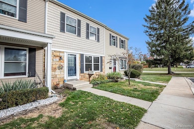 View of front of home featuring a front lawn and stone siding