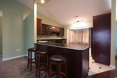 Kitchen featuring under cabinet range hood, a peni