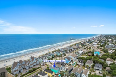 Aerial view featuring a water view and a beach vie