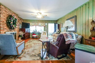 Living area featuring wood finished floors and ceiling fan