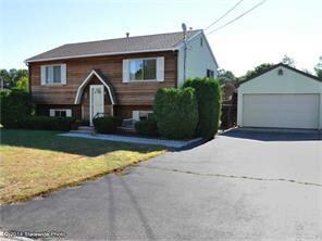 Exterior Front. Very large paved driveway and 2-ca