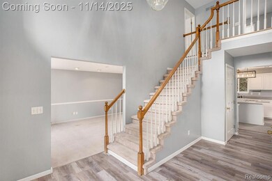 Staircase featuring a high ceiling, wood finished floors, and a chandelier