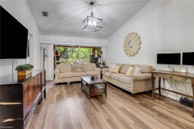 Living area featuring lofted ceiling, visible vent