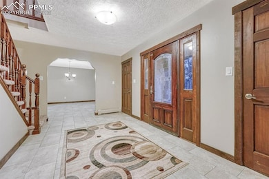 Entryway with baseboard heating, arched walkways, 