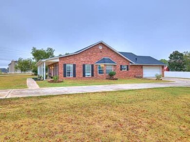 Ranch-style house with concrete driveway, a front lawn, and an attached garage