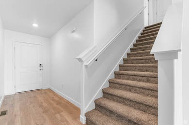 Foyer entrance featuring light wood-style flooring and stairway