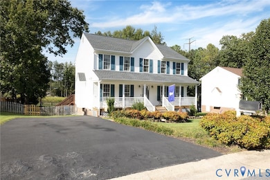 Colonial-style house featuring a porch and a shingled roof