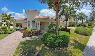 Mediterranean / spanish home featuring a tiled roof, decorative driveway, stucco siding, and a front yard