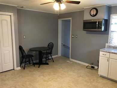 Kitchen area leading to bedroom and basement door