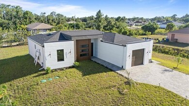 View of front facade with a front lawn, roof with 