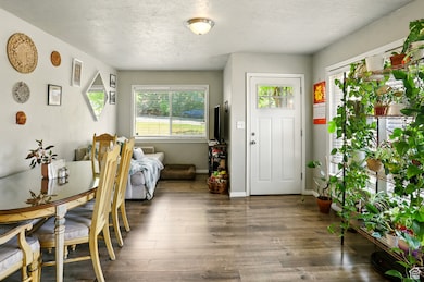 Foyer entrance with wood finished floors and a textured ceiling