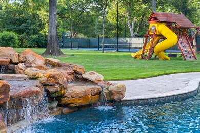 The custom pool with rock wall water feature, the