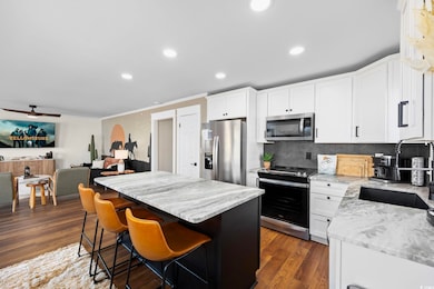 Kitchen with dark hardwood / wood-style flooring, 