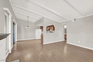 Unfurnished living room with lofted ceiling with b