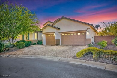 View of front facade featuring decorative driveway, an attached garage, stucco siding, and a tile roof