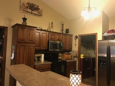 View of the kitchen from the end of the eating bar