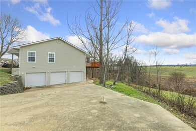 Driveway and 3 car garage/ Open and screened in porch/deck across back of house.