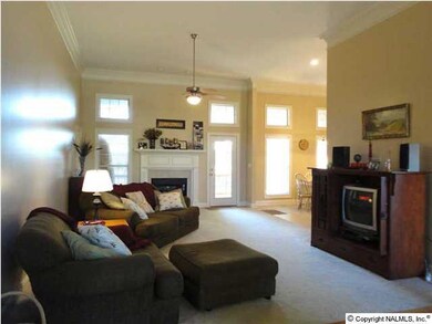 Over-sized great room with soaring ceiling and gorgeous fireplace, perfect for hanging out or watching a movie.