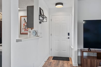 Doorway to outside with wood finished floors, a te