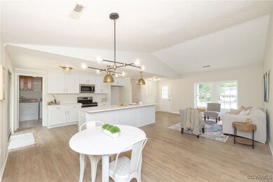 Dining space featuring lofted ceiling, light wood-