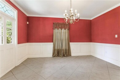 Dining room features framed front window, wainscot