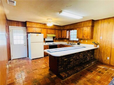 Kitchen with light countertops, visible vents, ele