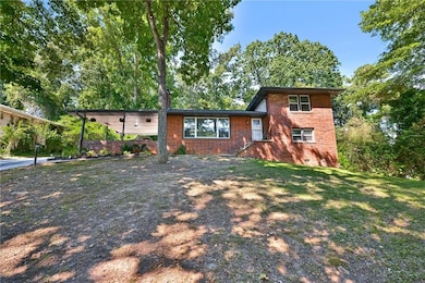 Tri-level home featuring crawl space, brick siding