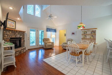 Dining area with a fireplace, high vaulted ceiling