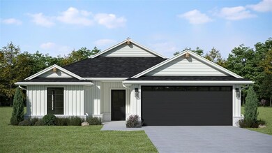 View of front of home with a garage and a front ya