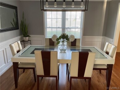 Dining Room with Hardwood Flooring, Crown Moulding