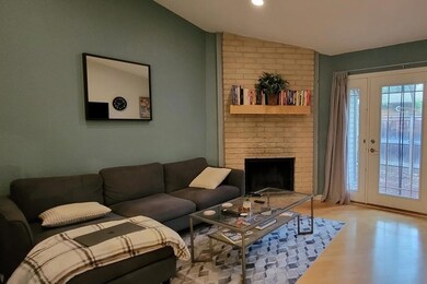 Living area featuring lofted ceiling, wood finish