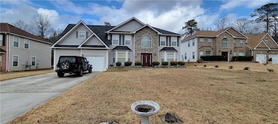 View of front of property with a garage and a fron