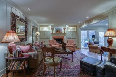Fantastic built-ins and fireplace in den. This vie
