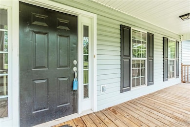 View of exterior entry with a porch