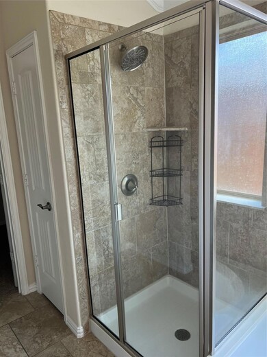 Full bath with a shower stall