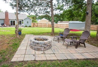 Your new backyard features a custom fire pit with 