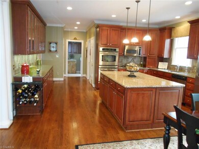 Lots of lighting. Laundry room can be seen in the far back along with pantry and half bath