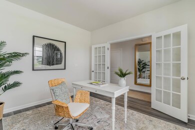 Office with wood finished floors, french doors, and baseboards