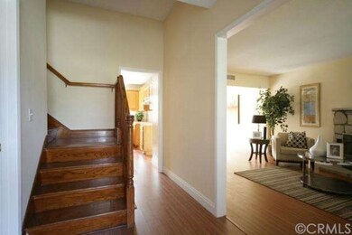 Entrance leads to gorgeous wooden staircase and Li