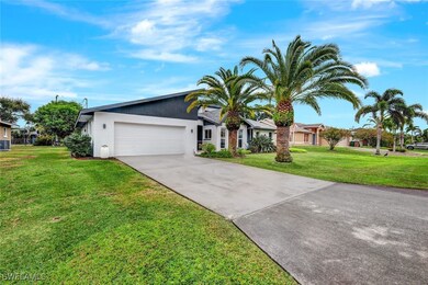 Single story home with a garage and a front yard